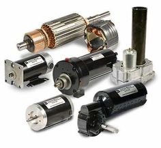 several different types of motor parts are shown in this image, including two motors and one is