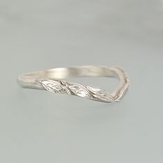 Wear a nature-inspired wedding ring that looks like it came straight from an enchanted forest with this intricately detailed leaf curved wedding band. Each ring is handmade specifically for you where a hand-wrought band of recycled sterling silver is set with tiny leaves along the front curvature of the ring. This nature-inspired curved ring would make a lovely non-traditional sterling silver wedding band for a nature lover, and can be worn alone, or stacked with a solitaire ring. Silver Curved Wedding Band, Curved Wedding Band White Gold, Leafy Wedding Band, Wedding Bands For Women Silver, Botanical Wedding Ring, Forest Rings, Boho Wedding Bands, Wedding Touches, Elven Ring