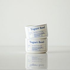 two yogurt bowls sitting side by side on a white countertop, with the words yogurt bowl printed on them