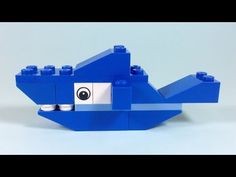 a blue lego toy with a face on it's head and eyes in the shape of a whale