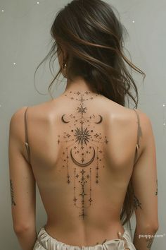 the back of a woman's body with stars and moon tattoos on her upper back