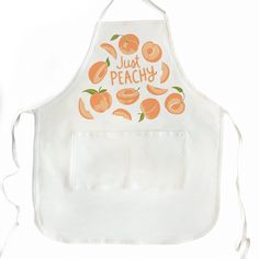 an apron that has peaches on it and the words just peachy written in orange