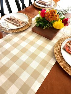 the table is set with plates and flowers