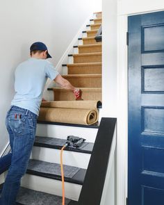 a man that is standing on some stairs with a hose in his hand and tape