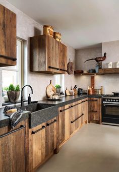 a kitchen with wooden cabinets and black counter tops is pictured in this image from the front view