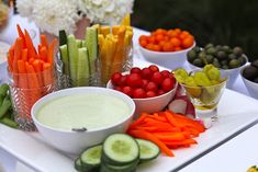 an assortment of veggies and dips on a table