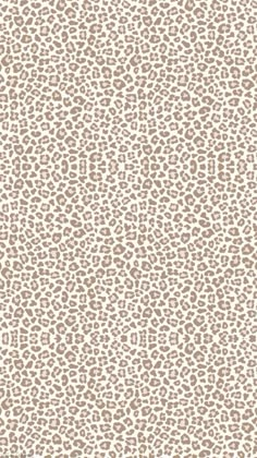 a white and brown animal print wallpaper with lots of small spots on it's surface