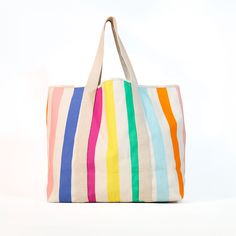 This catch all beach tote is the last pool bag you'll ever need to buy! Fits three beach towels, plus lots more. Durable canvas handles and a color stripe print make this a perfect summer tote. Canvas material. Would be so cute with an added monogram! Measures 23"x7"x16" Beach Day Essentials, Pool Bag, Summer Tote Bags, Bright Starts, Pool Bags, Trip Outfits, Summer Tote, Monogram Styles, Rainbow Design