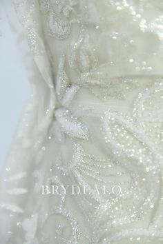 Shiny and delicate, this silver glitter lace fabric in pretty botanic shape is perfect for sparkly bridal dresses or accessories. * Glitters would drop a little bit, which is not quality issue. shown color light ivory sold by the yard content polyester, nylon width 130 cm washing instructions hand wash/drip dry White Shimmer Sequin Fabric For Wedding, Elegant White Sequin Fabric, White Glitter Sequin Fabric For Wedding, White Glitter Tulle Fabric For Wedding, Sparkly Dresses, Light Ivory, Sparkly Dress, Drip Dry, Silver Glitter