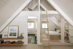 an attic bedroom with a loft bed and ladder leading up to the second floor area