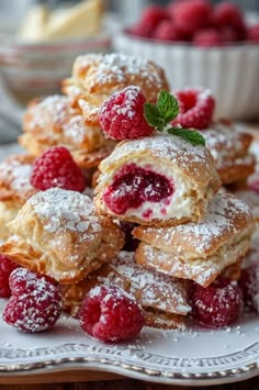 raspberry filled pastries stacked on top of each other with powdered sugar