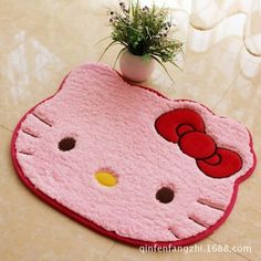 a hello kitty rug with a potted plant on it