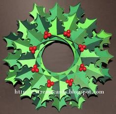 a christmas wreath made out of green paper with red berries and holly leaves on it