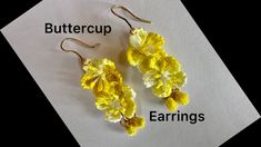 two pairs of yellow crocheted flower earrings on top of a piece of paper