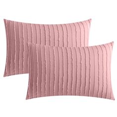 two pink pillows sitting next to each other on top of a white surface with pleated fabric