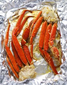 cooked lobsters and crab legs on tin foil