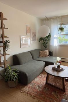 a living room with a couch, coffee table and bookshelf