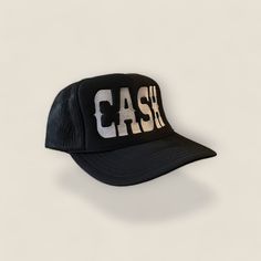 a black baseball cap with the word cash printed on it's front and side panels