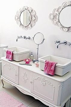 two white sinks sitting next to each other on top of a counter in a bathroom