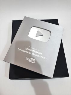 a silver youtube logo on top of two black folders