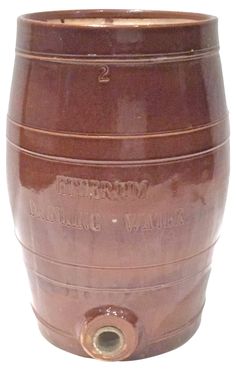 a large brown barrel sitting on top of a white surface