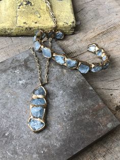 Inspired from waves crashing where the ocean meets the beach, four aquamarine are embedded in brass and anchored on our signature brass chain with a handmade clasp. Length 1 3/4" Width 3/4" Chain Length 16" - 18" This piece is handmade-to-order, please allow 1 - 2 weeks to ship unless this piece is in stock. Each piece will vary slightly due to the uniqueness of the stones. All metal is nickel free. Soldering Pendants, Unique Jewelry Inspiration, Soft Solder Jewelry, Metal Jewelry Handmade, Copper Electroformed Jewelry, Soldered Jewelry, Metal Jewelry Making, Raw Stone Jewelry, Ocean Necklace