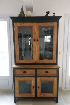 a black and wood china cabinet with glass doors