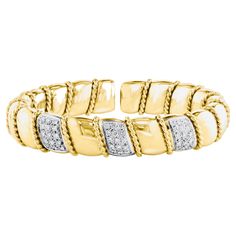 This exquisite vintage cuff bangle bracelet showcases two carats of dazzling diamonds set in an elegant 18 karat solid yellow gold. The bangle is designed with three bars adorned with round brilliant cut diamonds, creating a stunning visual appeal. It conveniently opens from one side, allowing for easy wearing. A beaded wire wrap encircles the entirety of the bangle, adding a touch of intricate detail. With a length that fits wrists ranging from 6.0" to 7", it is ideal for those with a medium wrist size. The bracelet weighs a total of 75 grams, further enhancing its substantial and luxurious feel. I have one more bangle in another listing as you can buy both to layer them. the other bangle has ruby sapphire and emeralds with alternating bars of diamonds. you will see some pictures here too Cuff Bangle Bracelet, Ruby Sapphire, Diamond Bangle, Cuff Bangles, 2 Carat, Round Brilliant Cut Diamond, Wire Wrap, Solid Yellow, Vintage Stil