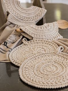 two crocheted placemats sitting on top of a table