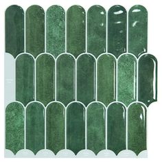 green glass tiles are arranged in rows on a white background, each with different shapes and sizes