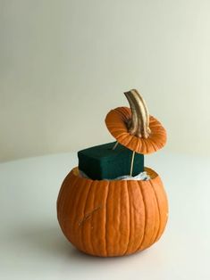 an orange pumpkin sitting on top of a white table