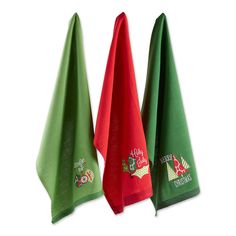 three christmas towels hanging up on a white wall, one green and the other red