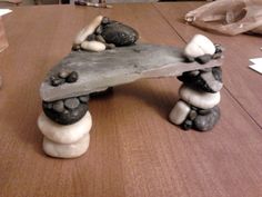 a wooden bench made out of rocks on a table