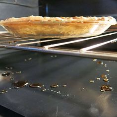 a pie baking in an oven with oil on it