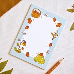 a notepad with an image of a frog on it next to a pencil and some leaves