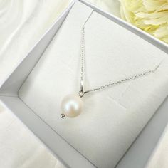 PEARL NECKLACE  Necklace Length: 40 cm  Pearl Type: Swarovski pearl Pearl Size: 10 mm Necklace material: 925 Sterling silver Packaging: The necklace comes thoughtfully packaged in a jewelry box. Additionally you can order in a gift box, if you wish.  Swarovski Pearl Elegance: The White Drop Pearl Necklace features pearl from Swarovski, known for their unrivaled radiance and luxurious appeal. These pearls elevate the appearance and quality of the necklace. Perfect Gift Idea: The White Pearl Neckl Pearl Bridal Necklace Gift, Pearl Bridal Necklace With Pearl Pendant, Pearl Bridal Necklace With Pearl Pendant As Gift, Bridal Pearl Necklace With Pearl Pendant As Gift, Bridal Necklace With Pearl Pendant As Gift, Pearl White Bridal Necklace With Pearl Pendant, Bridal Pearl Pendant Necklace With Round Beads, Silver Pearl Necklace With Charm For Bridesmaids, Round Pearl Necklaces For Bridesmaid Gift