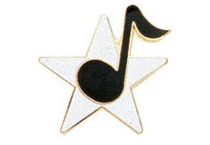 a black and white pin with a musical note on it's side, in the shape of a star