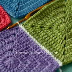 three crocheted squares sitting next to each other on top of a blue table