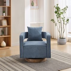 a blue chair sitting on top of a wooden floor next to a book shelf filled with books