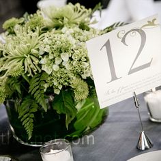 the table is set with candles, plates and place cards for guests to sit at