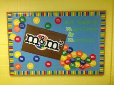 a bulletin board with the word m & m on it in front of a classroom wall