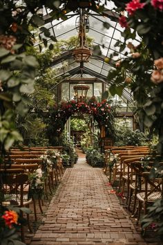 a brick walkway leads to a greenhouse filled with flowers and greenery