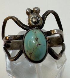 Vintage Cortez H Navajo Sterling Silver Turquoise Spider Ring 11 1/2 Signed inside band Cortez H Size 11 1/2 oval Turquoise stone measures 3/8" x 1/4" Spider ( face of ring) measures approx 5/8" x 3/4" Weighs 4.88g Not marked silver but has been tested as STERLING SILVER  ALL PRECIOUS METALS ARE TESTED 3 WAYS ACID,RARE EARTH MAGNET AND PROFESSIONAL ELECTRONIC METAL TESTER TO INSURE PURITY* *Vintage coin and ruler are for size reference ONLY and NOT included PLEASE LOOK AT ALL PICTURES CAREFULLY Adjustable Oval Turquoise Ring With Patina, Vintage Oval Turquoise Ring With Large Stone, Untreated Adjustable Oval Turquoise Ring, Unique Oval Turquoise Collectible Ring, Unique Oval Turquoise Ring With Patina, Artisan Oval Turquoise Collectible Ring, Vintage Turquoise Ring With Large Oval Stone, Southwestern Adjustable Oval Turquoise Ring, Vintage Adjustable Turquoise Cabochon Ring