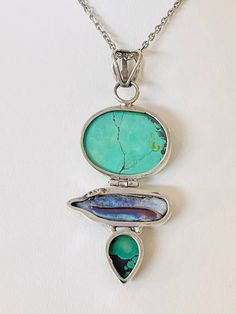 This is a very unusual combination! Turquoise top, purple pearl in the middle with a turquoise bottom, all bezel set in sterling silver. GREAT COLORS! Marries the land and the sea. This piece weighs 12.3 grams. Turquoise Top, Glendale Az, Turquoise And Purple, Purple Pearl, Pearl Pendant, The Land, Bezel Setting, Turquoise Necklace, The Sea