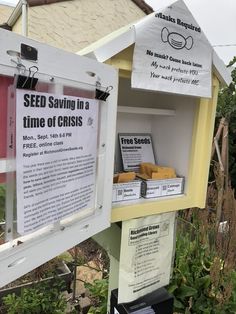 seed saving in a time of crisis sign next to some boxes