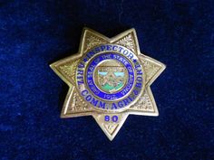 a police badge sitting on top of a blue velvet surface