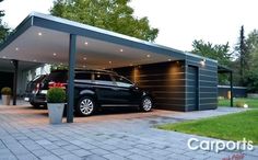 a black van parked in front of a garage with lights on it's side