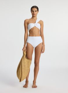 The Athena Bikini Top in white is crafted from our structured and fade-resistant swim fabric sourced from Italy and made in the USA, with incredible stretch and recovery. This two-piece top features a twisted one-shoulder strap and a wide back panel for a secure fit. This style runs true to size. Shop Swim Styling Tip: Pair with coordinated bikini bottoms, slim sunglasses, and an oversized tote when waterside. Slim Sunglasses, White Two Piece, Luxury Lifestyle Women, White Bikinis, Oversized Tote, White Swimsuit, White Tie, Ready To Wear, High Waist