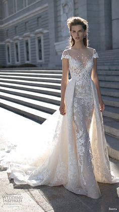 a woman in a wedding dress standing on some steps