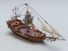 a wooden model of a pirate ship with sails and two masts, on a white background